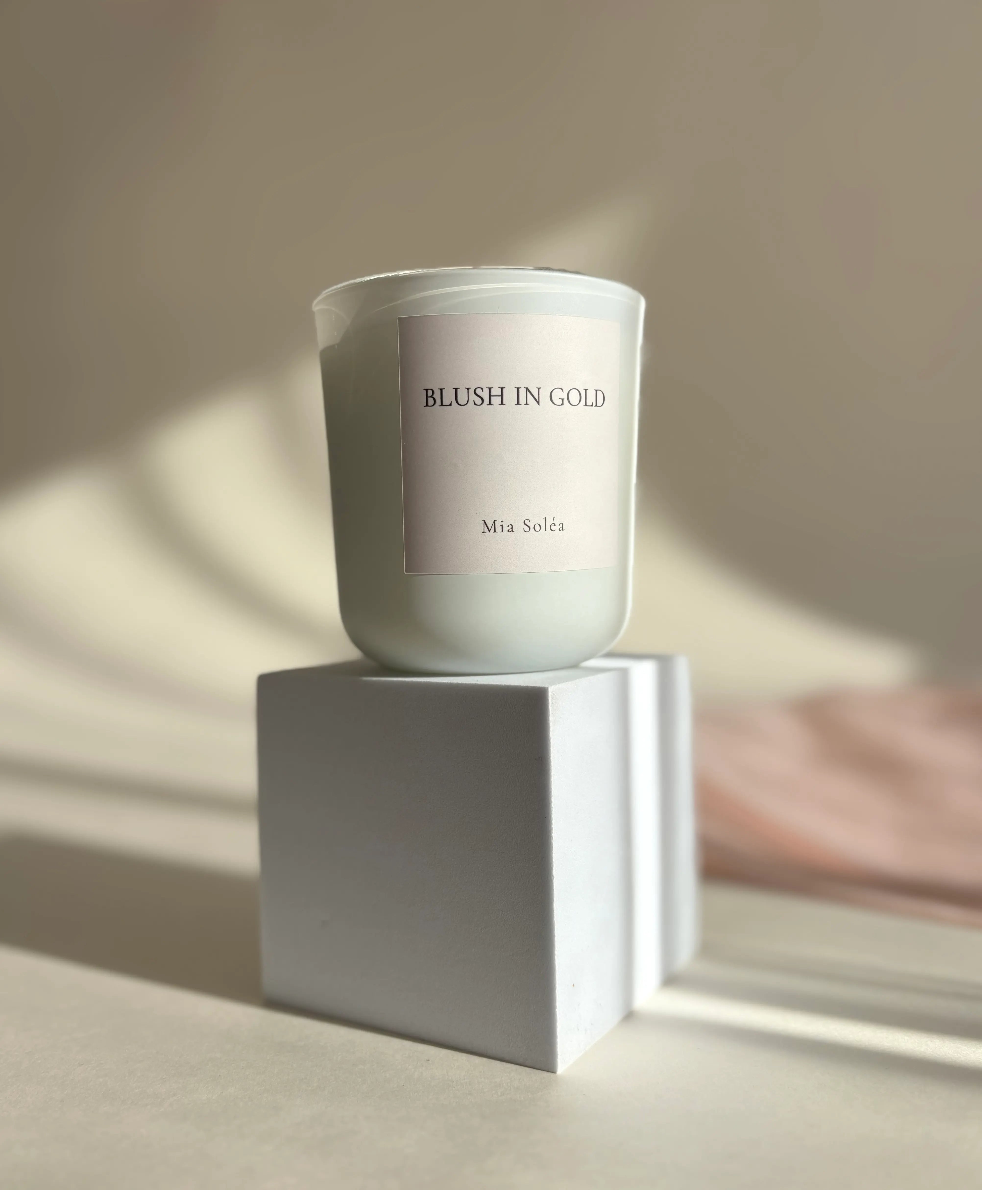 Luxury perfume-inspired candle aesthetic in golden hour lighting